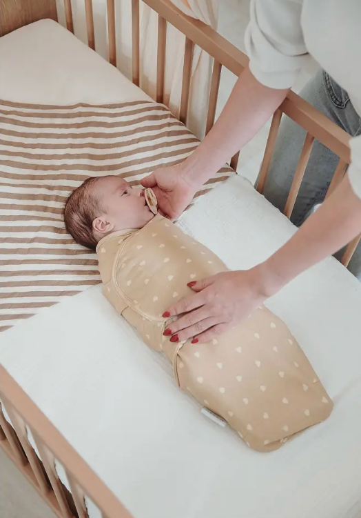Baby svøbt i Swaddle babysvøb der skaber tryghed og bedre søvn i tremmeseng